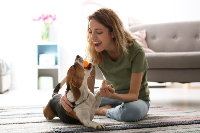 woman bonding with dog at home