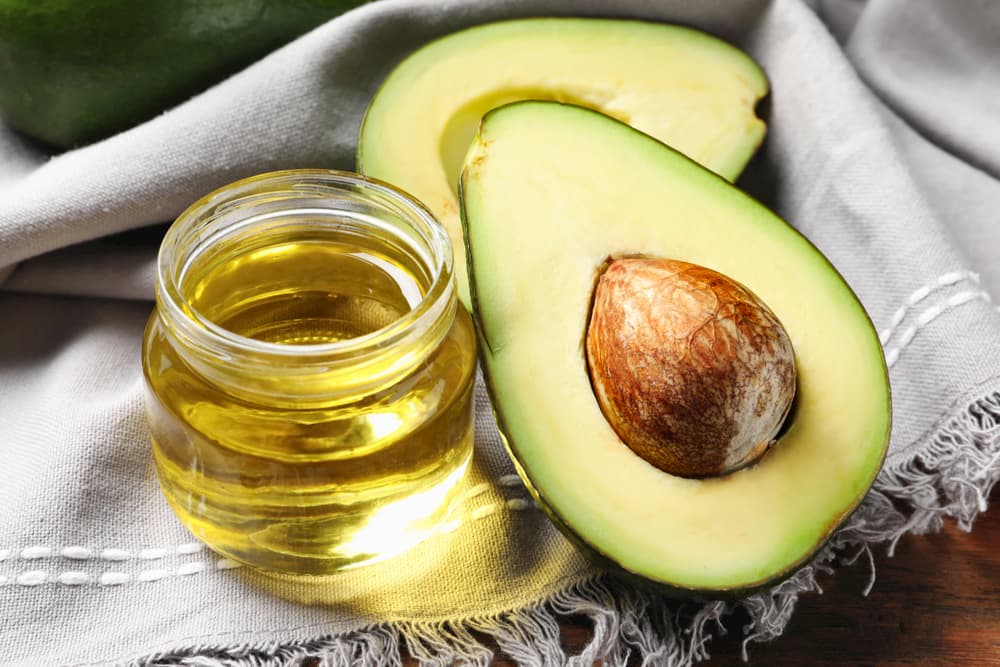 Avocado and avocado oil on a cloth