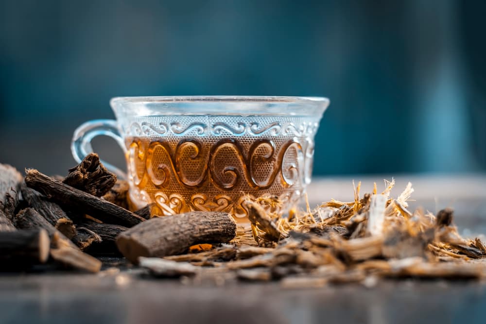 Licorice root branch and tea on table