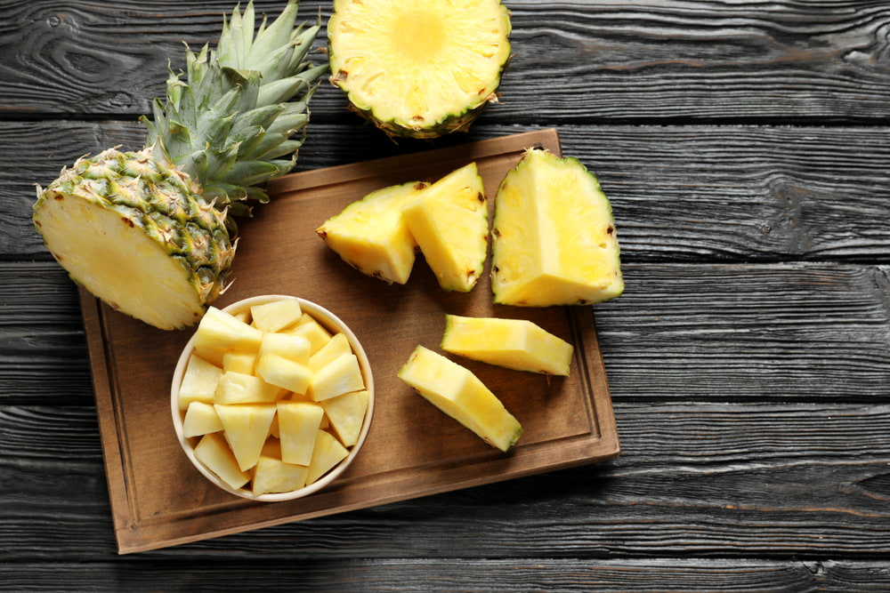 Fresh pineapple on cutting board