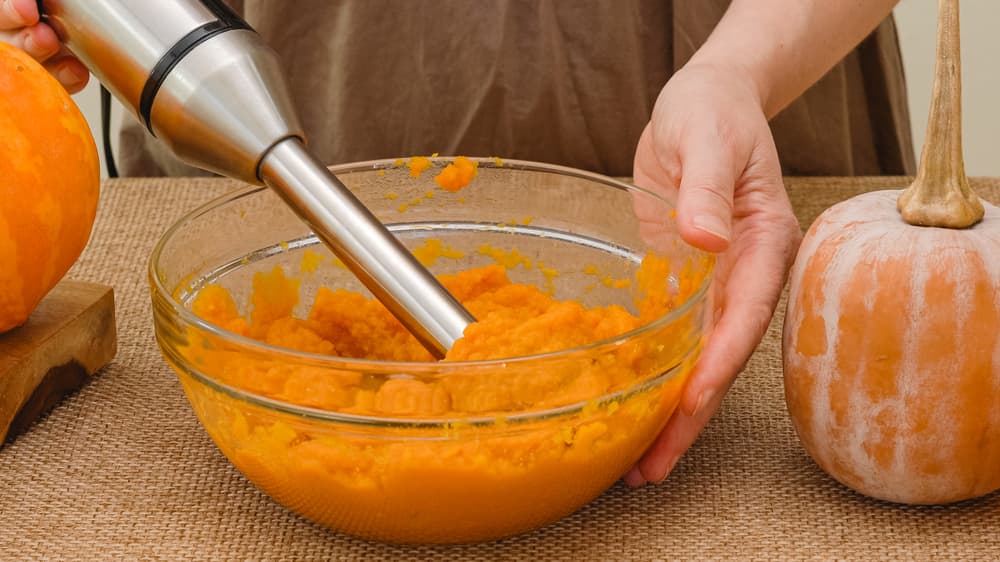 Woman pureeing pumpkin