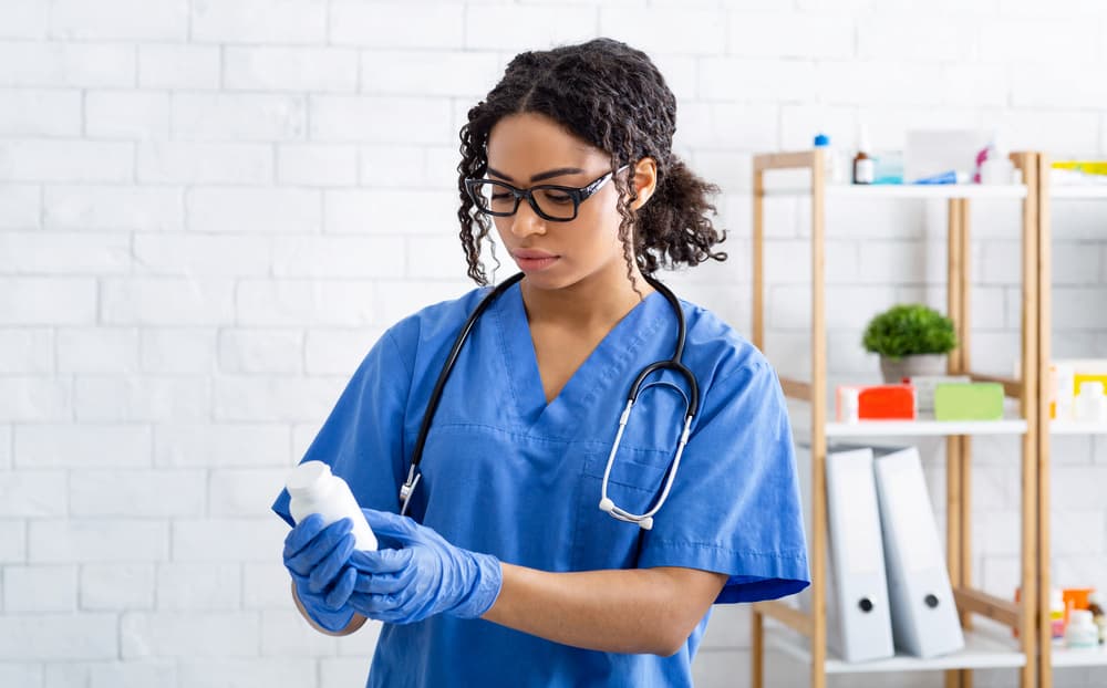 Veterinarian looks at prescription bottle