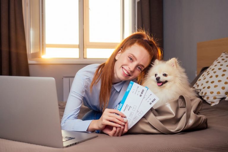 woman with dog and airline tickets