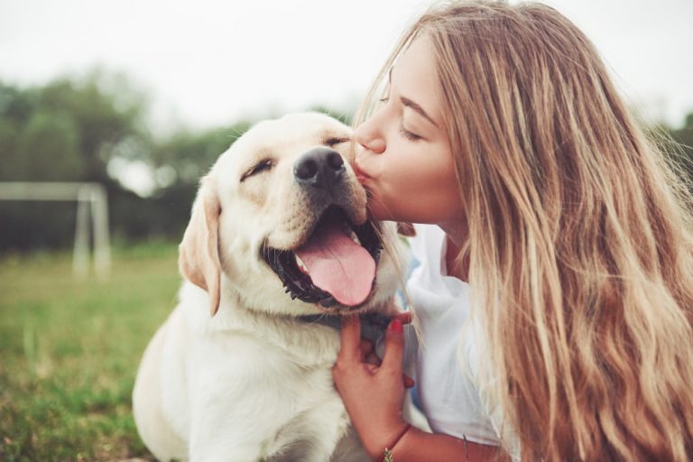 Woman hugging Labrador retriever